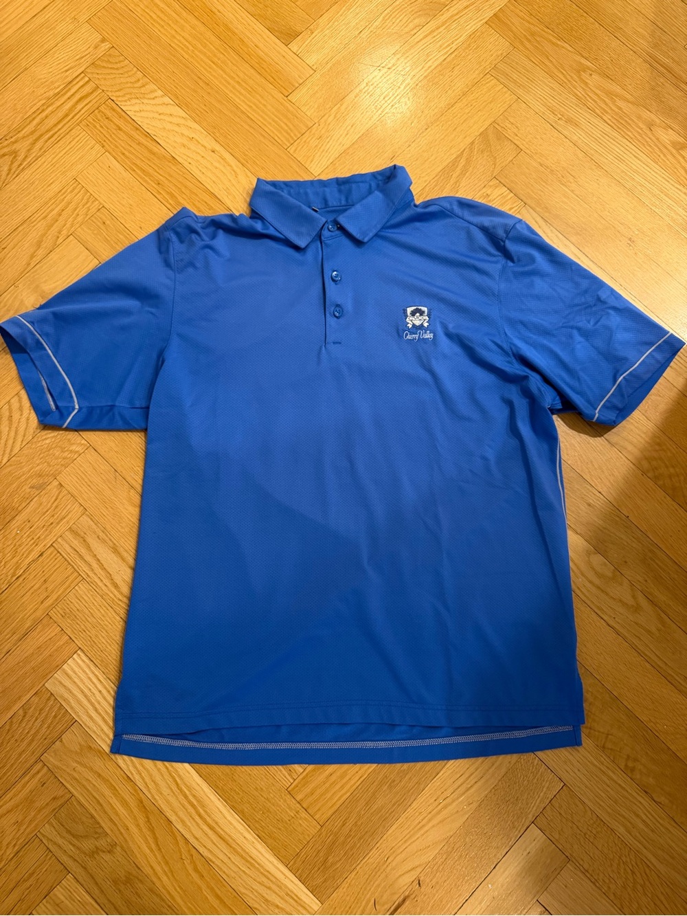 Under Armour Coldblack Loose Fit blue polo with “Cherry Valley” logo